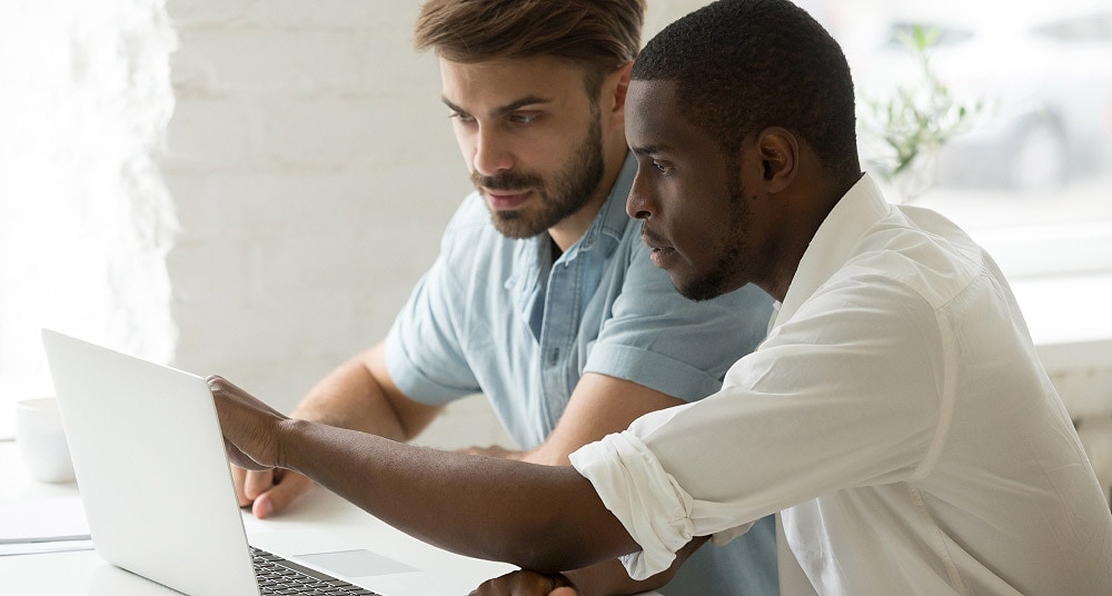 Two people reviewing a laptop together